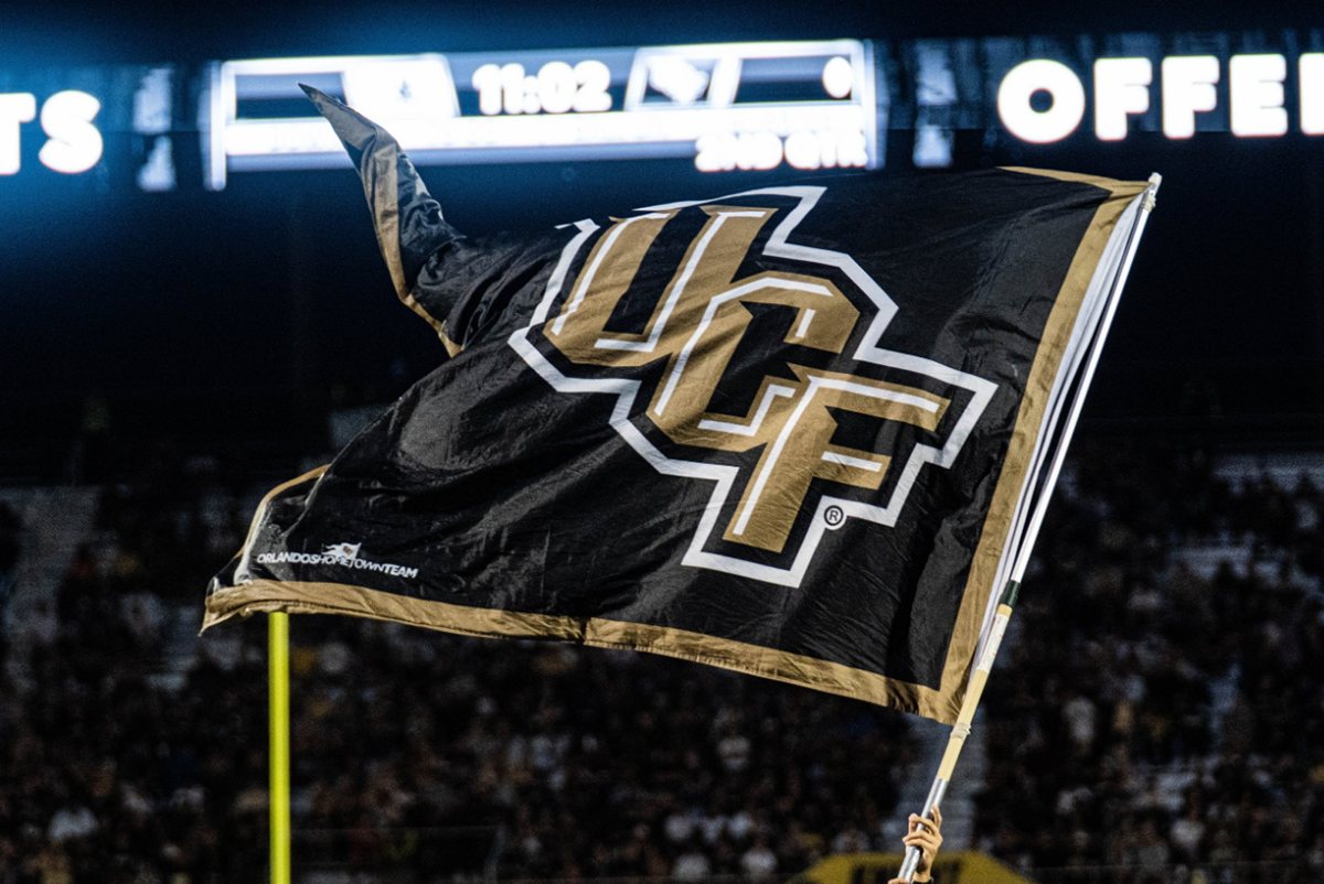 UCF flag waving over the crowd at the Bounce House