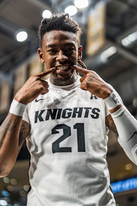 UCF Knights number 21 grinning at the crowd after a bucket